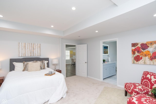 bedroom with recessed lighting, baseboards, connected bathroom, and light colored carpet