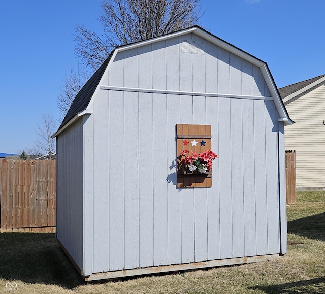 view of shed featuring fence