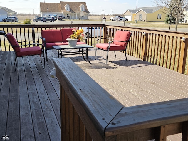 wooden terrace with a residential view and outdoor lounge area