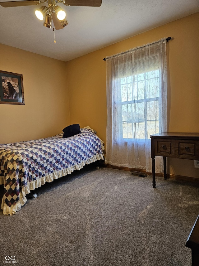 bedroom featuring ceiling fan, carpet flooring, and baseboards