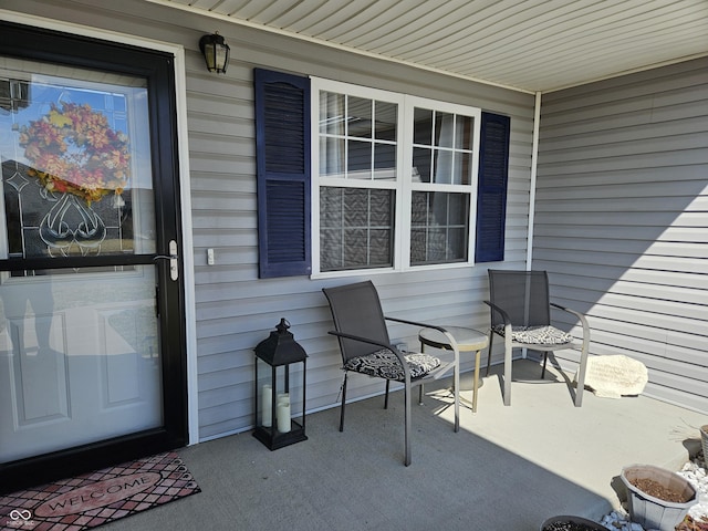 view of exterior entry with a porch