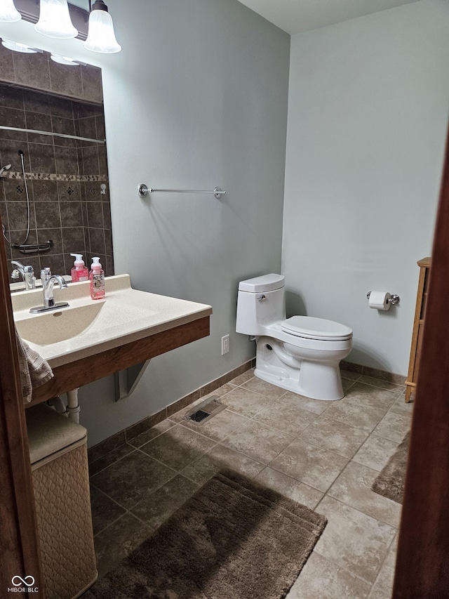 bathroom with baseboards and toilet