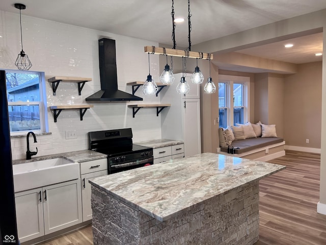 kitchen with ventilation hood, open shelves, electric range, a sink, and light wood-type flooring