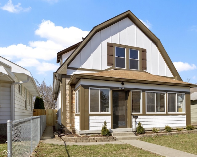 view of front facade featuring board and batten siding and fence