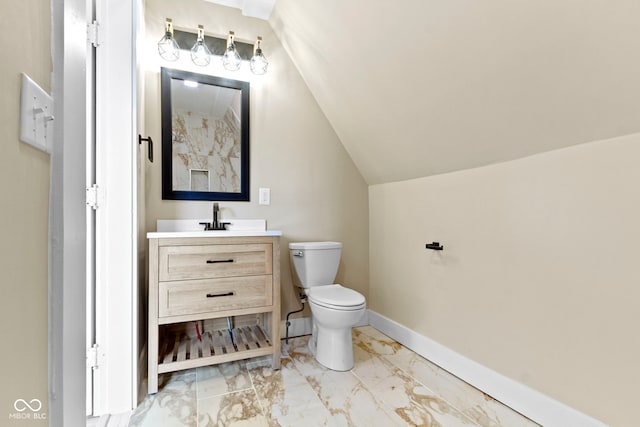 bathroom with baseboards, toilet, vaulted ceiling, marble finish floor, and vanity