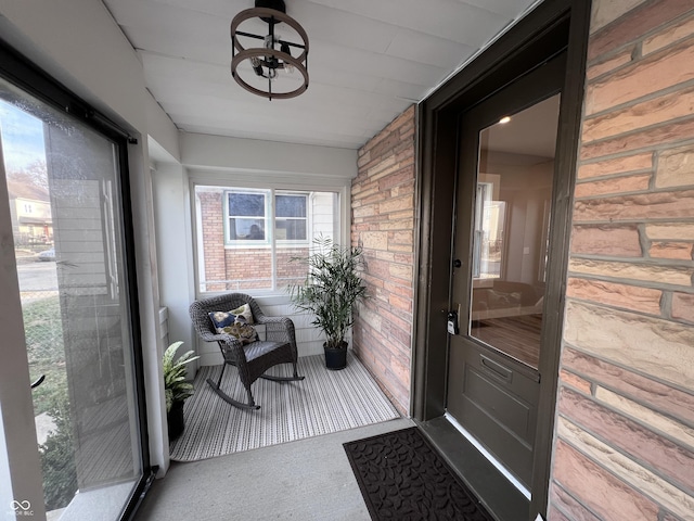 sunroom / solarium with an inviting chandelier