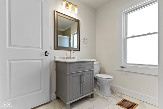 bathroom with visible vents, toilet, marble finish floor, baseboards, and vanity