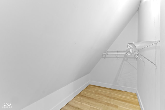 walk in closet featuring lofted ceiling and light wood-style flooring