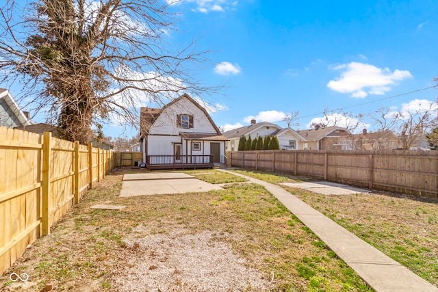 back of house with an outdoor structure, a lawn, a fenced backyard, and a patio area