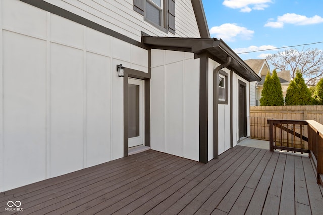 wooden terrace featuring fence