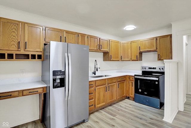 kitchen featuring light wood-style flooring, light countertops, stainless steel refrigerator with ice dispenser, a sink, and range with electric stovetop