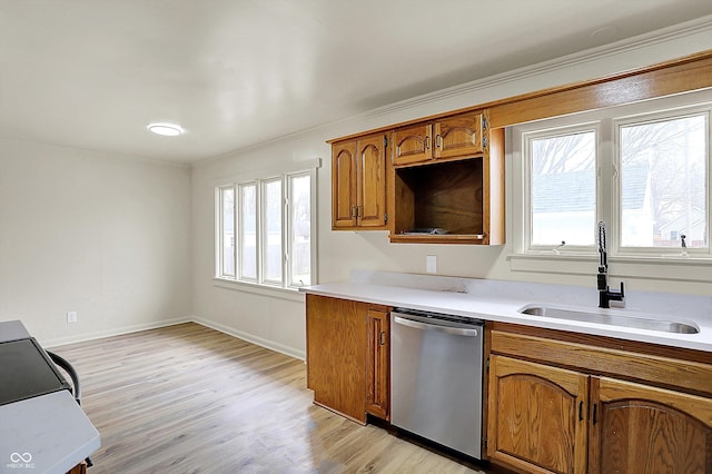 kitchen featuring light countertops, brown cabinets, a sink, and stainless steel dishwasher