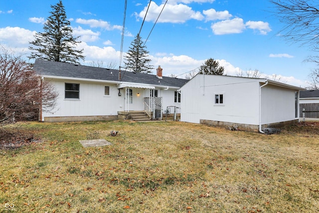 back of property with a yard and a chimney