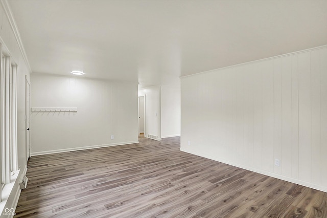 unfurnished room featuring baseboards and wood finished floors