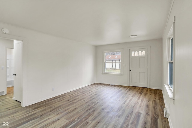 entryway featuring baseboards and wood finished floors