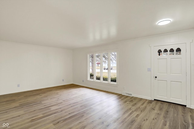 entrance foyer featuring light wood-style flooring, visible vents, and baseboards