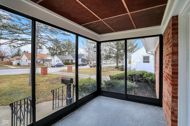 unfurnished sunroom featuring a residential view