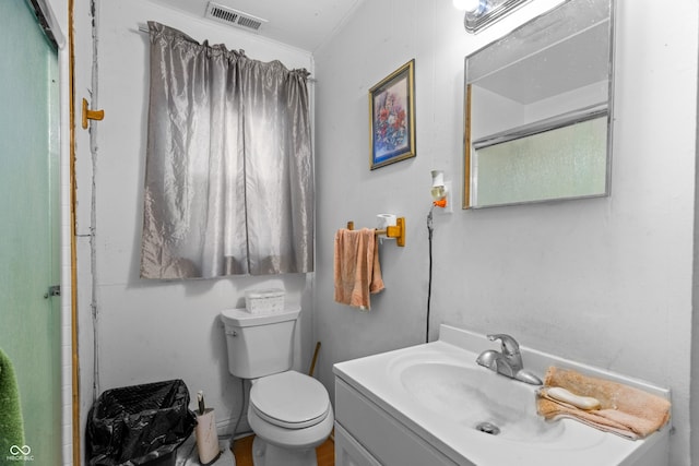 bathroom with toilet, a shower, vanity, and visible vents