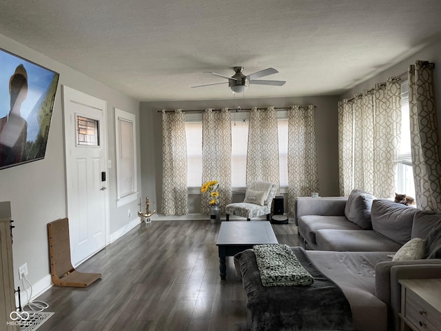 living area with plenty of natural light, a textured ceiling, and wood finished floors