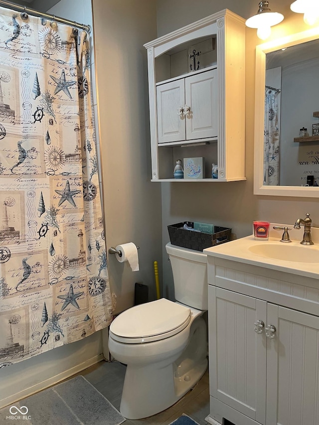 bathroom featuring toilet, shower / bathtub combination with curtain, and vanity