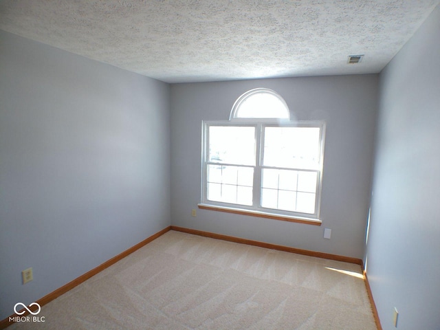 unfurnished room featuring light carpet, plenty of natural light, visible vents, and baseboards