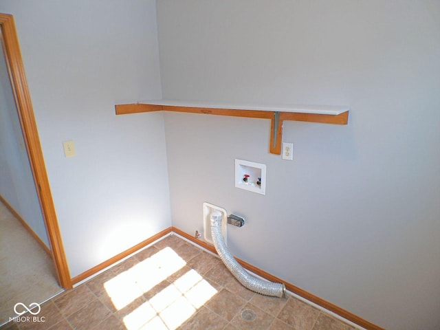 washroom with hookup for a washing machine, laundry area, and baseboards