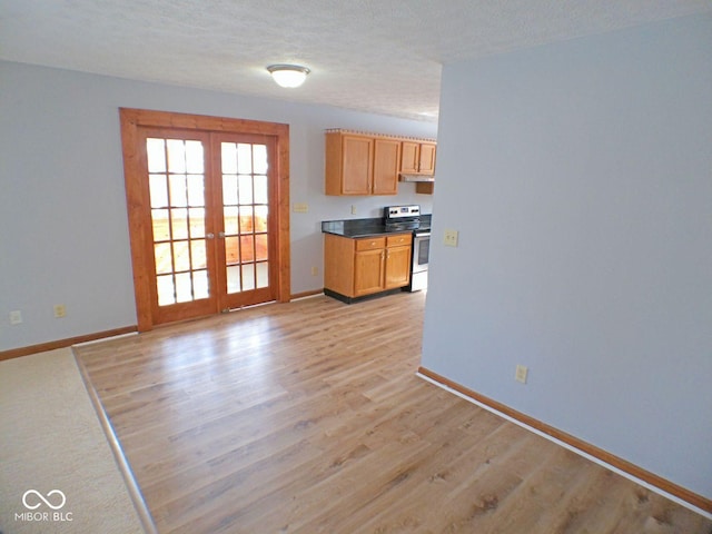 kitchen with light wood finished floors, baseboards, stainless steel range with electric cooktop, a textured ceiling, and french doors