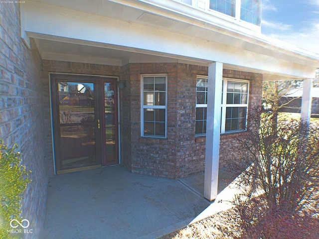 property entrance with brick siding