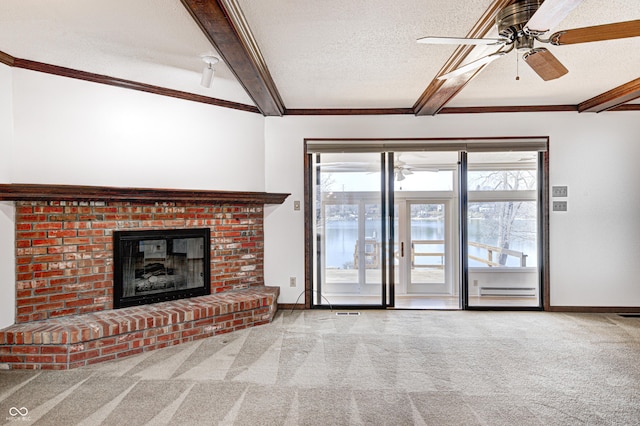 unfurnished living room with beam ceiling, a textured ceiling, carpet, and a ceiling fan