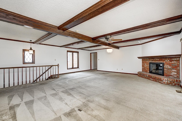 unfurnished living room featuring baseboards, carpet floors, beam ceiling, ceiling fan, and a textured ceiling