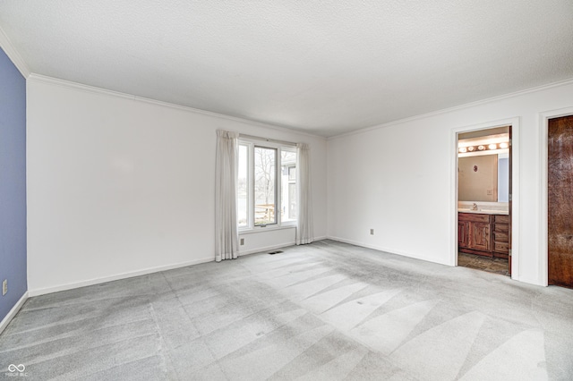 unfurnished room with light carpet, a textured ceiling, and crown molding