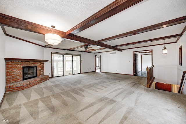 unfurnished living room with crown molding, baseboards, carpet floors, beam ceiling, and a textured ceiling