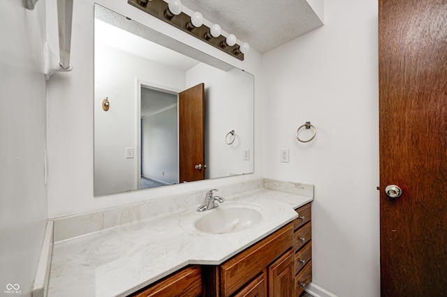 bathroom with vanity and a textured ceiling