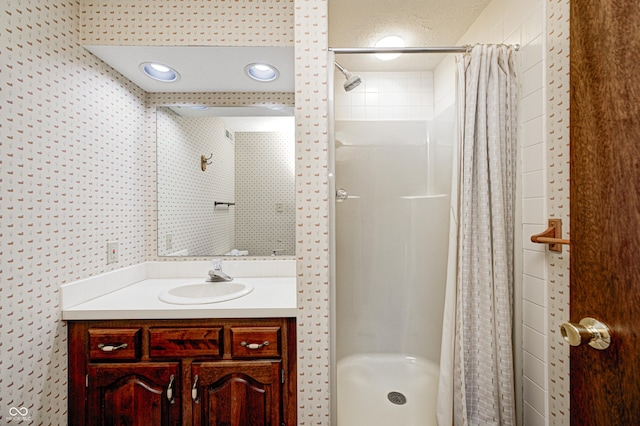 full bath featuring a stall shower and vanity