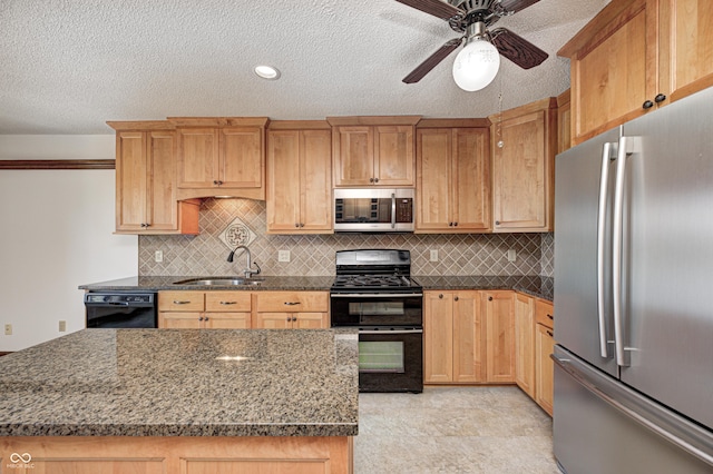 kitchen with black appliances, a sink, tasteful backsplash, a textured ceiling, and ceiling fan