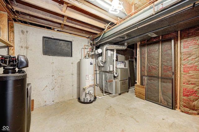 unfinished below grade area featuring heating unit and gas water heater