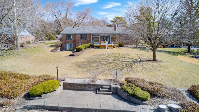 back of property featuring a yard and a chimney