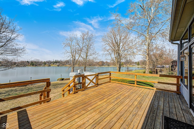 wooden terrace featuring a water view