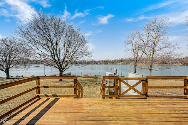 wooden deck with a water view and a dock