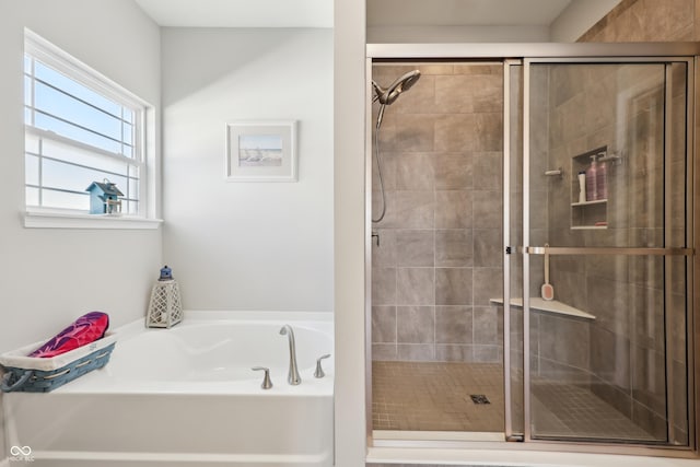 full bathroom featuring a shower stall and a bath