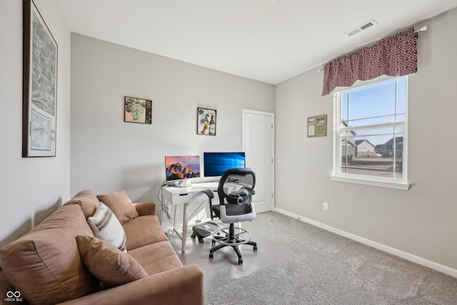 carpeted office with visible vents and baseboards