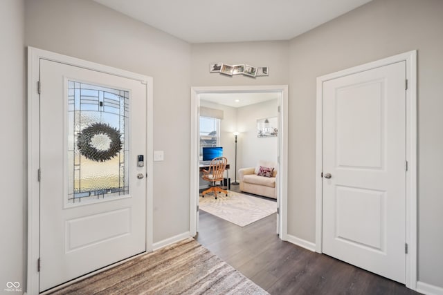 entrance foyer featuring baseboards and dark wood-style flooring