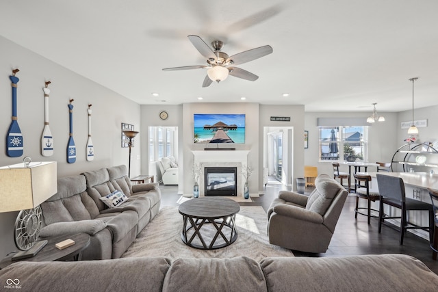 living room with recessed lighting, a fireplace with flush hearth, ceiling fan, and wood finished floors