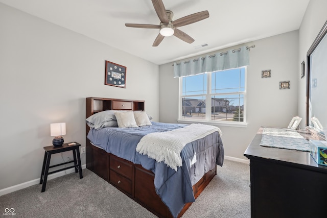 carpeted bedroom featuring visible vents, a ceiling fan, and baseboards