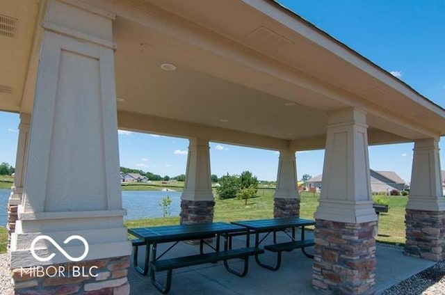 view of patio featuring a porch and a water view