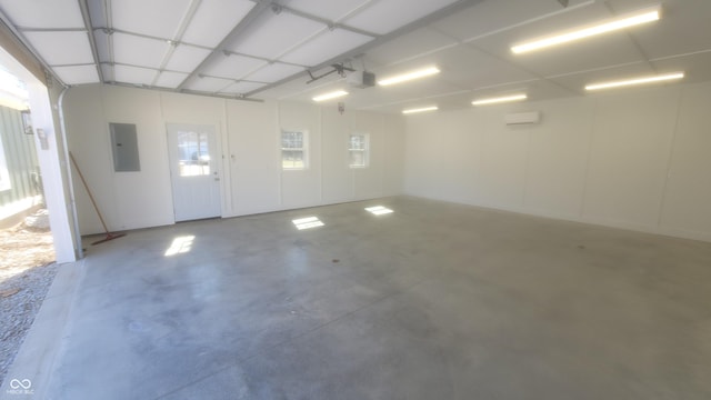 garage with electric panel, a garage door opener, and a wall mounted AC