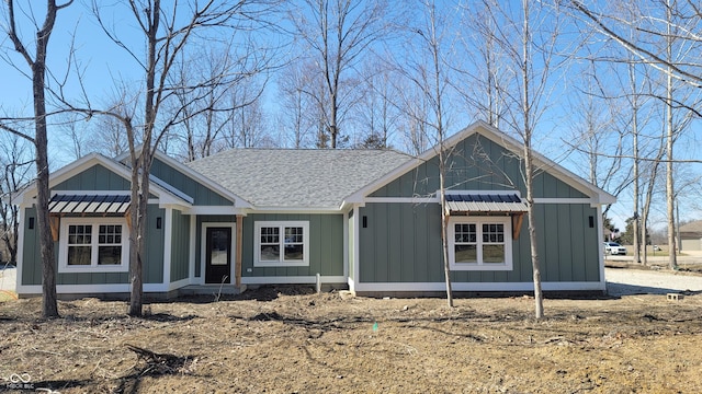 view of front facade featuring board and batten siding and a shingled roof