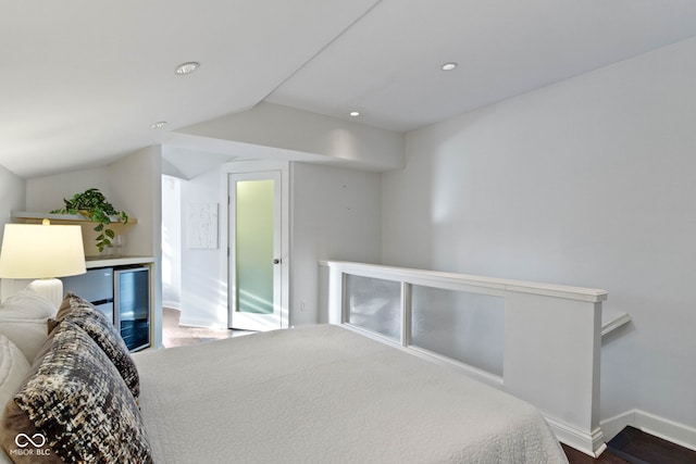 bedroom with wine cooler, baseboards, vaulted ceiling, and recessed lighting