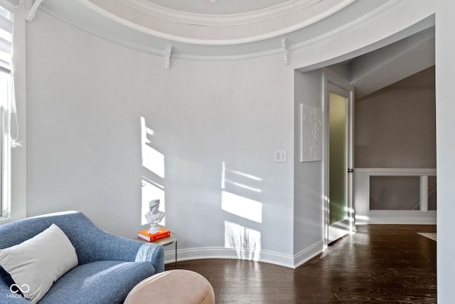 sitting room with ornamental molding, baseboards, and wood finished floors