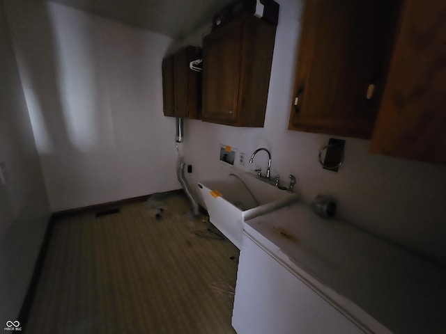 clothes washing area with washer hookup, cabinet space, and a sink